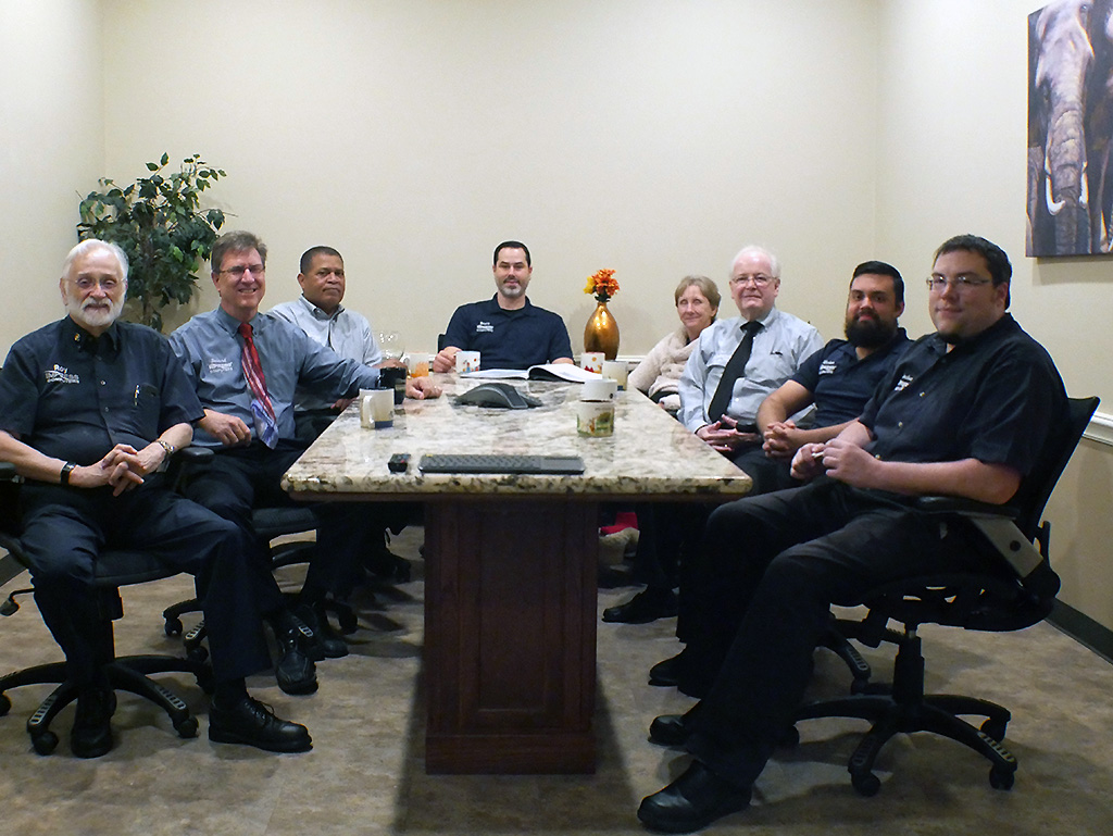 Group of people seated around a conference table in a meeting room